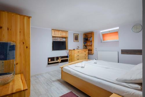 a bedroom with a large bed and a television at The Secret Spot 1BD Apartment in Sofia