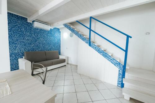 a living room with a staircase and a couch at Gioema in Borgo Vodice