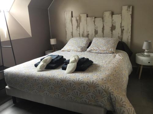 a bedroom with a bed with two towels on it at LO PASTRE - LUXUEUX T2 in Laguiole