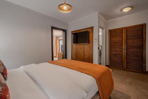 a bedroom with a bed and a television in it at Hotel Centro Bodrum in Bodrum City