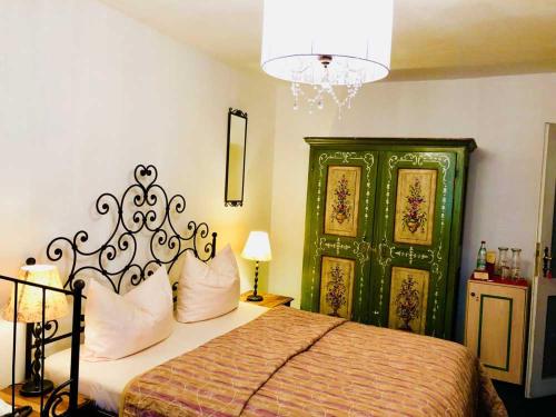 a bedroom with a bed and a green door at Hotel Mariahilf München in Munich