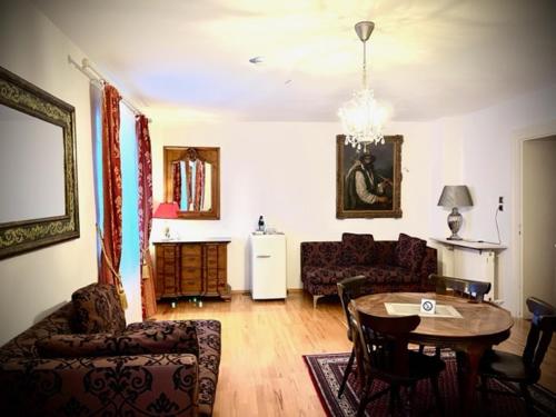 a living room with a table and a couch at Hotel Mariahilf München in Munich