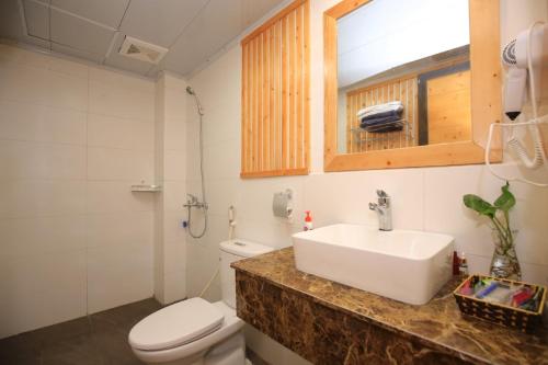a bathroom with a sink and a toilet at Acasa Panorama Homestay in Vĩnh Phúc