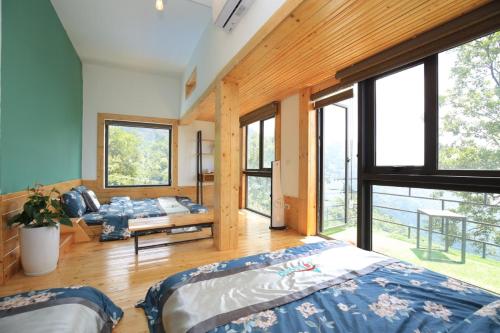a bedroom with two beds and a large window at Acasa Panorama Homestay in Vĩnh Phúc