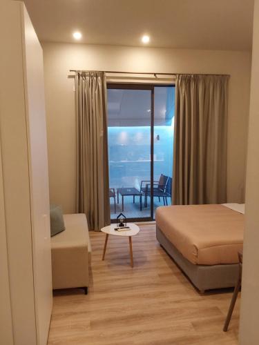 a bedroom with a bed and a view of the ocean at TheJoy Residence Apartments in Chania Town