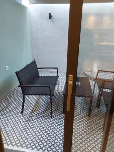 a black chair and a table in a room at TheJoy Residence Apartments in Chania Town