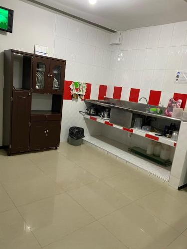 a kitchen with red and white tiles on the wall at Confort 13-47 in Cali