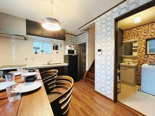 a kitchen and dining room with a table and chairs at Rakuyado kyotofushimi I in Kyoto