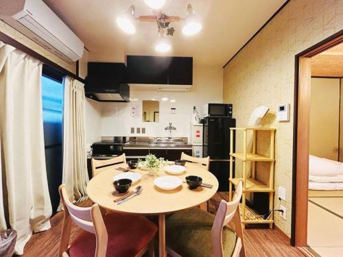 a kitchen and dining room with a table and chairs at Rakuyado kyotofushimi II in Kyoto
