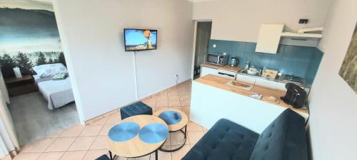 a kitchen with two blue chairs and a counter at Ania i Damian in Solina