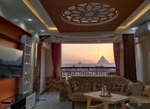 a living room with a couch and a table at Giza Pyramids View Apartment in Cairo