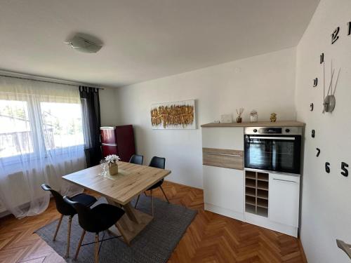 a kitchen with a wooden table and a dining room at Matija in Gospić