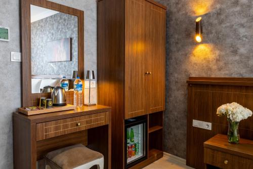 une chambre d'hôtel avec une coiffeuse et un miroir dans l'établissement Diamond Beyazit Hotel, à Istanbul