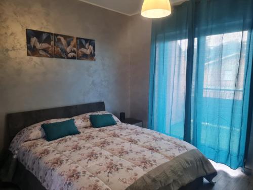Ένα ή περισσότερα κρεβάτια σε δωμάτιο στο Perla B&B