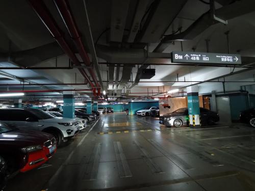 a parking garage with cars parked in it at Interact China Fine Condo - Shenzhen Bay in Shenzhen
