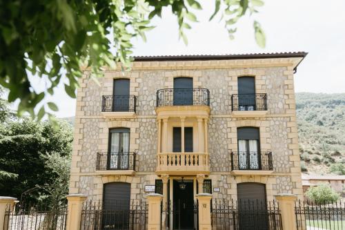 a large stone house with a black gate at Casa Montero in Viniegra de Abajo