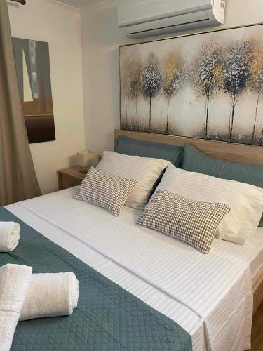 a bedroom with a bed with two pillows on it at MANOLIS COTTAGE THANOS in Thános