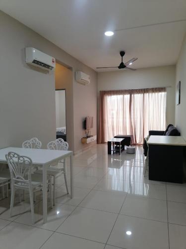 a living room with a white table and chairs at Enjoy the sunset @ Bright mesahill condo in Nilai