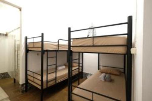 two bunk beds in a room with a window at OYO 93860 Wonosobo Bunkbed in Wonosobo