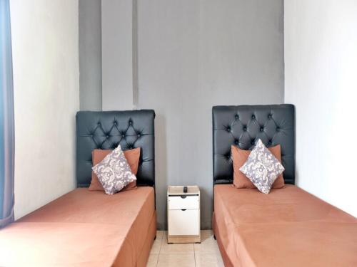 Postel nebo postele na pokoji v ubytování Pasifik Hotel Jakarta