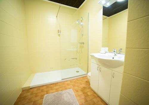 a white bathroom with a shower and a sink at Keutschacherhof in Keutschach am See