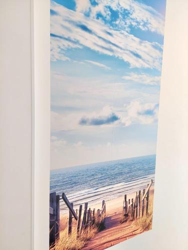 a picture of a beach with the ocean at Maison LYDIE - Meublé de vacances 3 étoiles in Charleroi