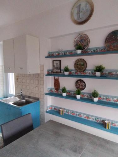 a kitchen with blue shelves and a sink at Appartament holidays Sistiana in Sistiana
