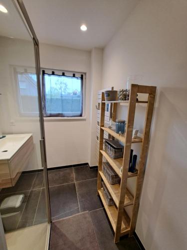 a bathroom with a walk in shower and a shelf at Chez Eve&Bruno 