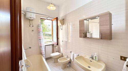a bathroom with a sink and a toilet and a bath tub at Villa La Magnolia in Ischia