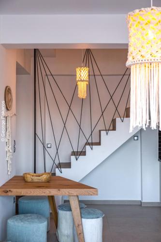 a dining room with a table and a staircase at Villa Hendel Lefkada in Lygia
