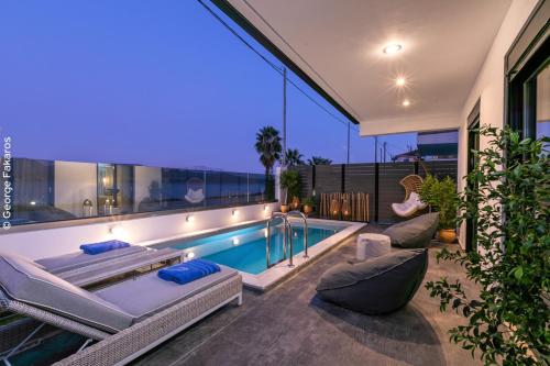 a house with a swimming pool and a patio at Villa Hendel Lefkada in Lygia