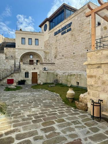 a large stone building with a stone courtyard at Solem Cave Suites in Urgup