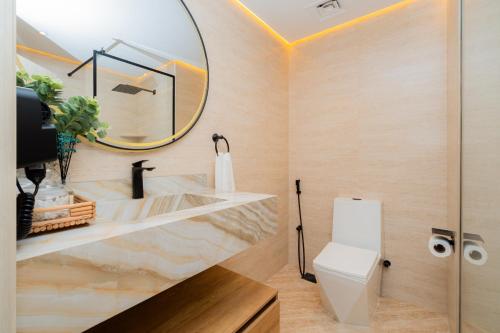 a bathroom with a sink and a mirror at Dubai Marina - 1BHK Apartment in Dubai
