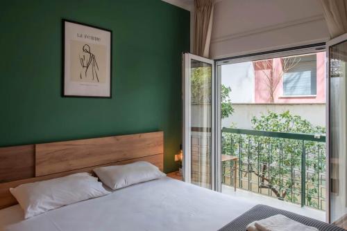 a bedroom with a bed and a green wall at Iris luxury apartment in Athens