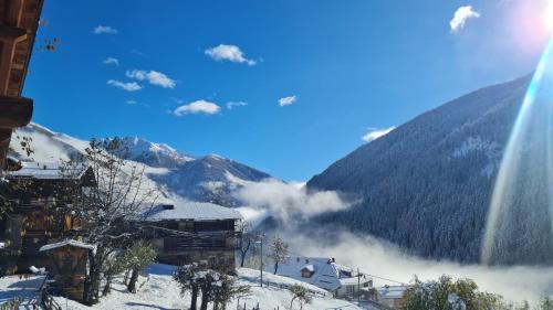 a view of a ski resort with a snow covered mountain at Mas del Mezdì - mountain chalet Val di Rabbi in Rabbi