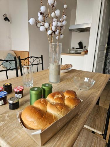 une table avec un plateau de pains dessus dans l'établissement Le Flamand Rose à 300 de la plage - 400m du centre ville, au Grau-du-Roi