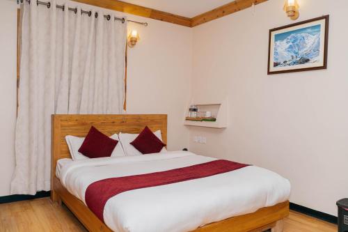 a bedroom with a large white bed with red pillows at Bardali Restro and Residency in Kathmandu