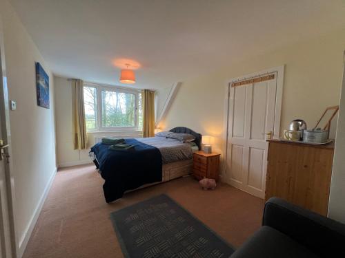 a small bedroom with a bed and a window at The Folly in Draughton