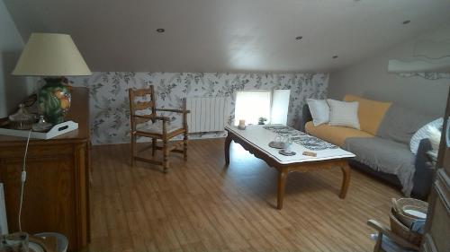 a living room with a couch and a coffee table at Chambre d'hôtes de Marie in Chémery