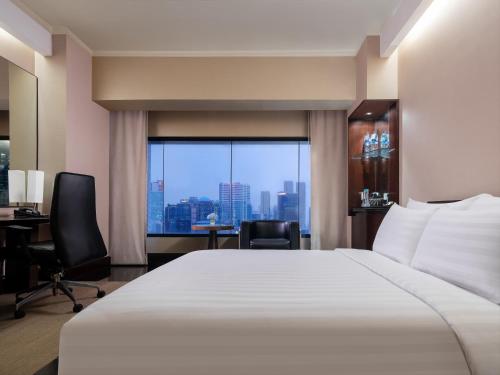 Ein Bett oder Betten in einem Zimmer der Unterkunft Manhattan Hotel Jakarta