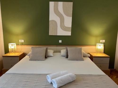 a bedroom with a large bed with two towels on it at Perina Apartment - free parking in Dubrovnik