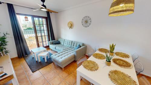 a living room with a couch and a table at Holidoo "Roda Village" in Roda