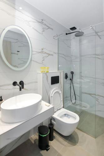 a bathroom with a sink and a toilet and a shower at AR APARTMENTS in Nikiti