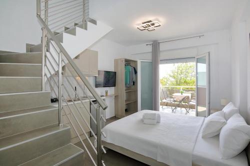 a bedroom with a bed and a spiral staircase at AR APARTMENTS in Nikiti