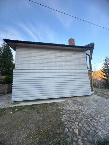 a large white garage with a roof on top at RIVIERA in Lekechi