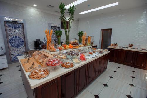 a buffet line with many plates of food on it at Ada Hotel in Tashkent