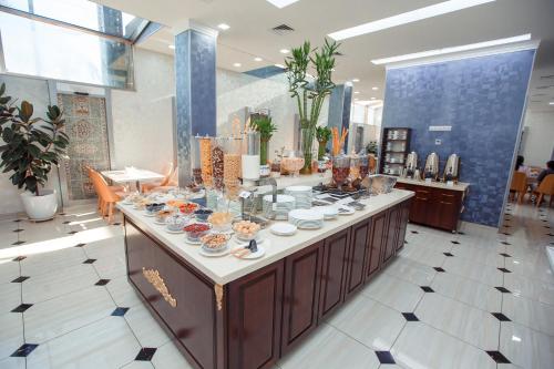 a buffet in a store with dishes on it at Ada Hotel in Tashkent