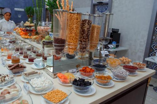 a buffet with many bowls of food on a table at Ada Hotel in Tashkent