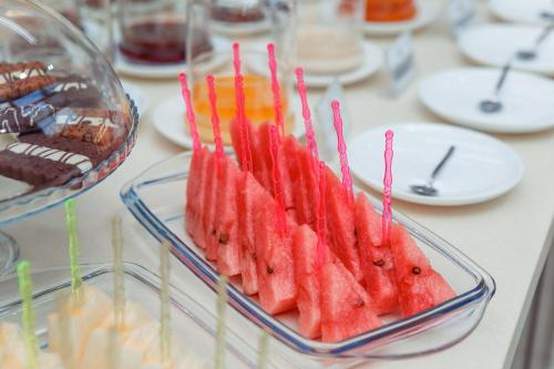 a glass bowl filled with watermelon on a table at Ada Hotel in Tashkent