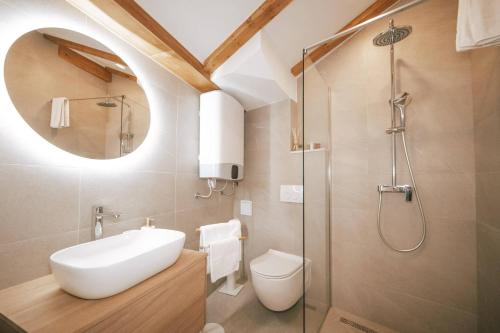 a bathroom with a toilet and a sink and a shower at Mascheroni Luxury Rooms in Dubrovnik